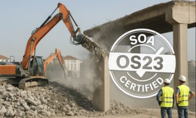 Workers and machines safely demolishing a building in Italy with an SOA OS23 certified mark.”